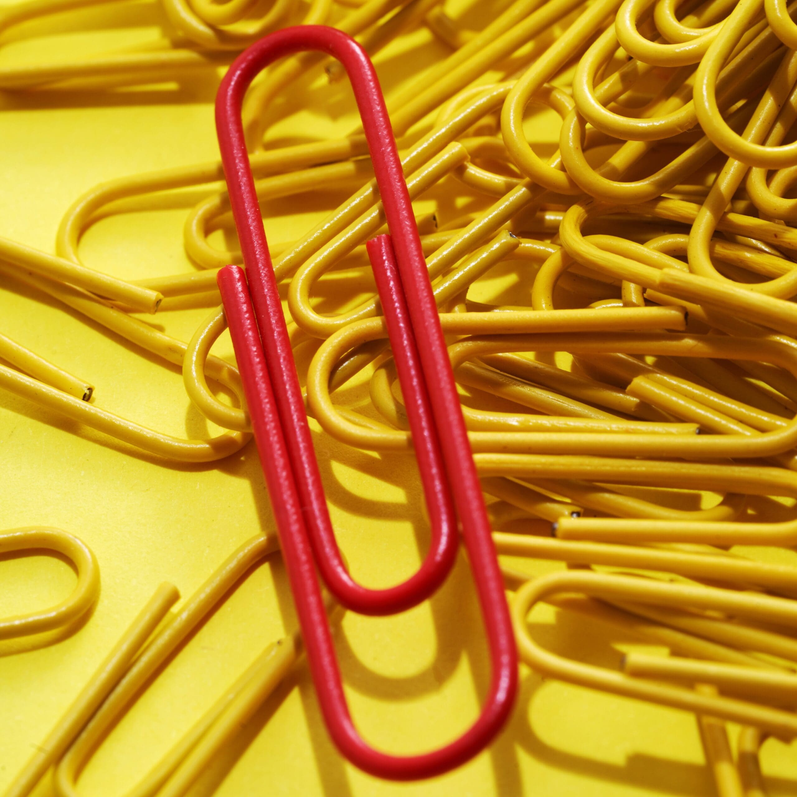 yellow color Paper clips on yellow background